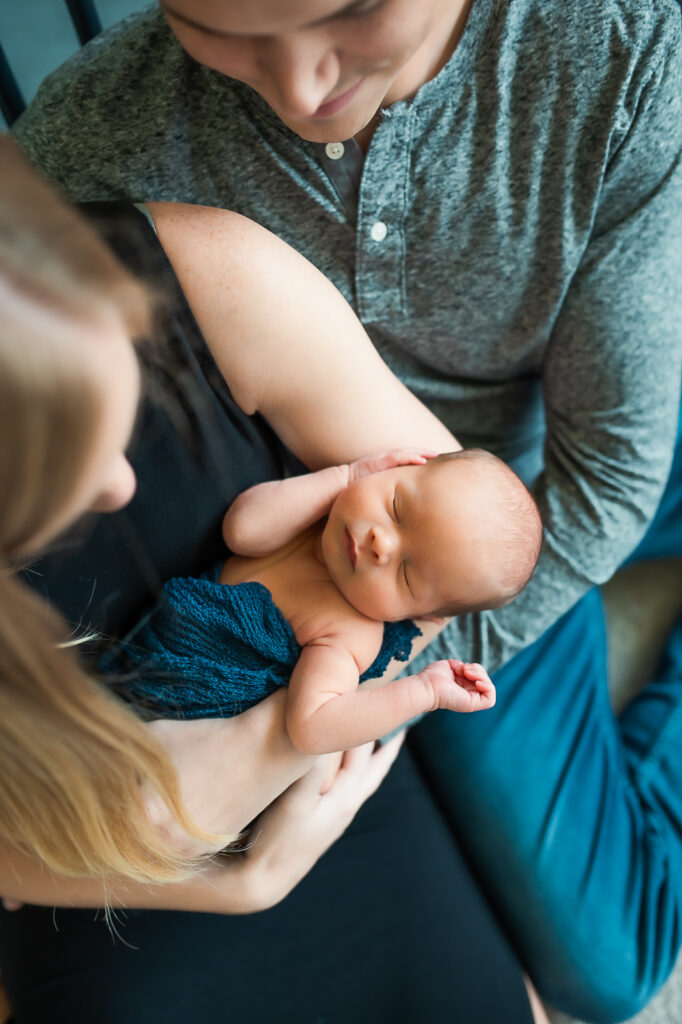 lifestyle newborn session with mom holding baby boy