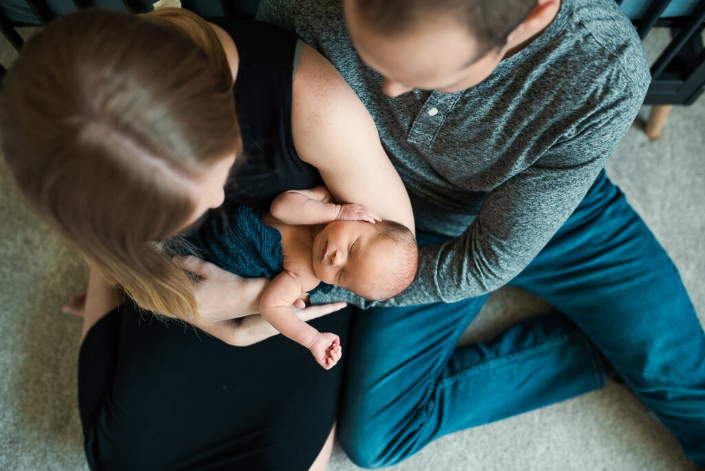 lifestyle newborn session with mom holding baby boy