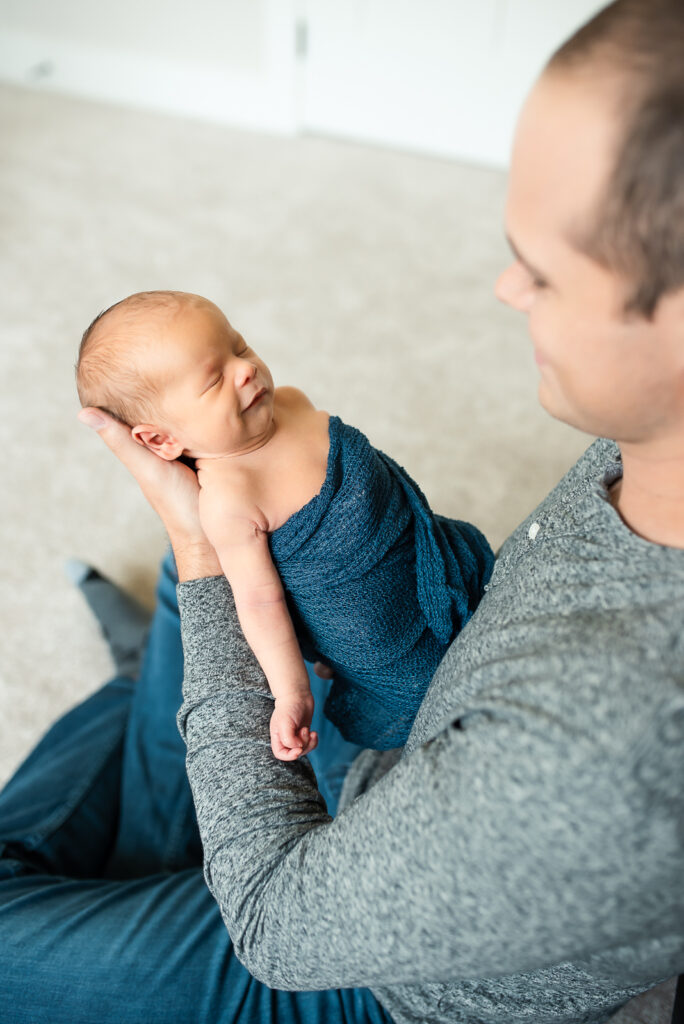 lifestyle newborn session with mom holding baby boy