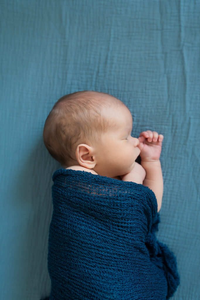 lifestyle newborn session with mom holding baby boy