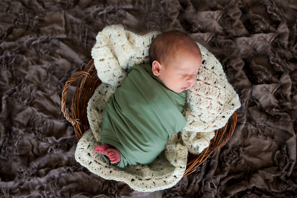 lifestyle newborn session with mom holding baby boy