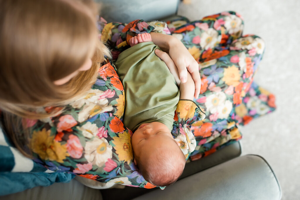 lifestyle newborn session with mom holding baby boy