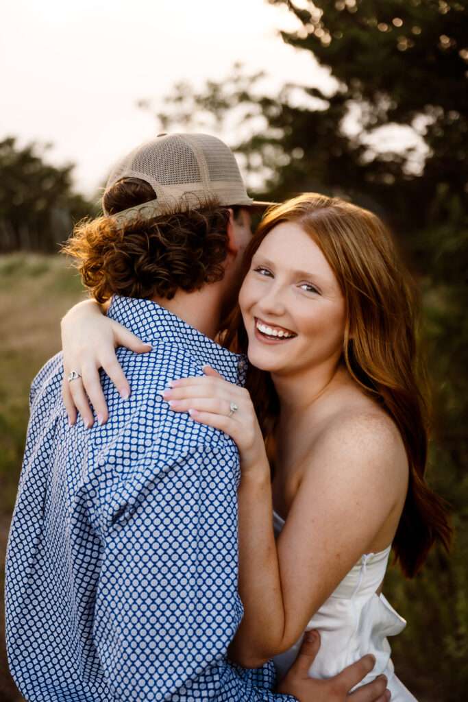 a couple embraces while Shelly Voss documents their engagement session