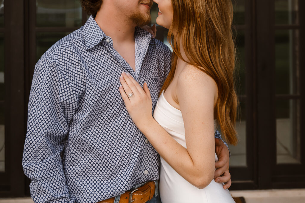 a couple sneaks a kiss during their engagement session captured by Shelly Voss photography 
