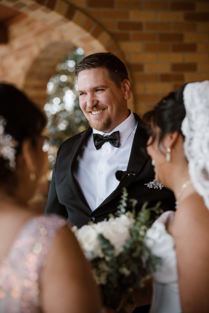 the groom shares smiles with family as they exit the church.
