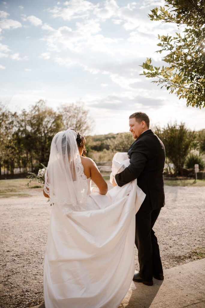 brides and groom walk during golden hour while having their photo taken
