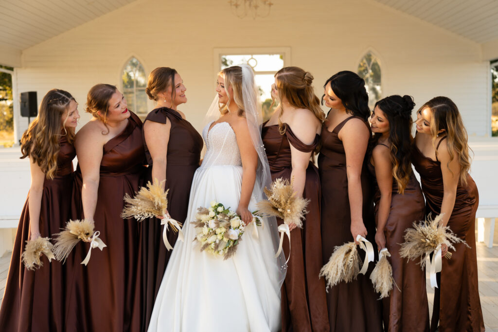 Bride holding bouquet in natural light bridal suite at Chandelier Farm
