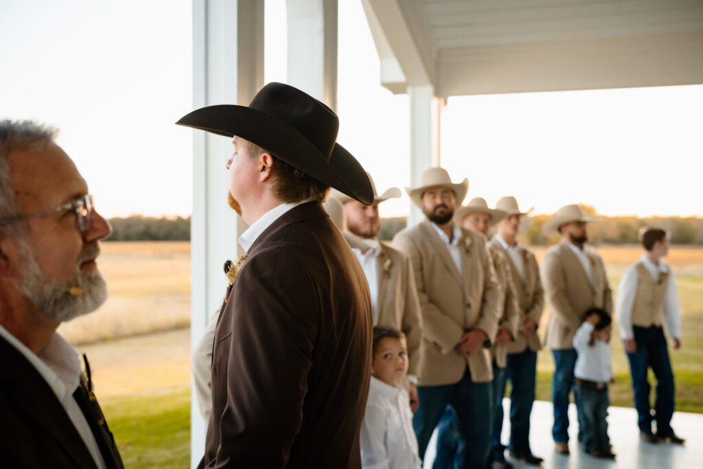 Groom wiping away tears during chapel ceremony at Chandelier Farm wedding venue
