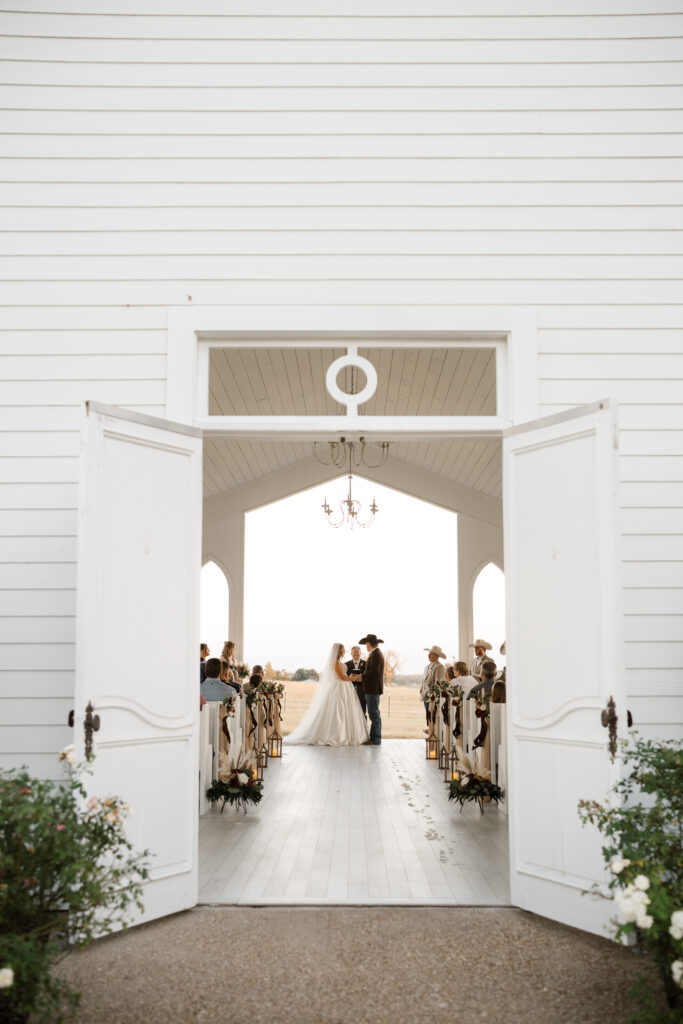 Wedding guests seated in chapel at Chandelier Farm in Terrell Texas
