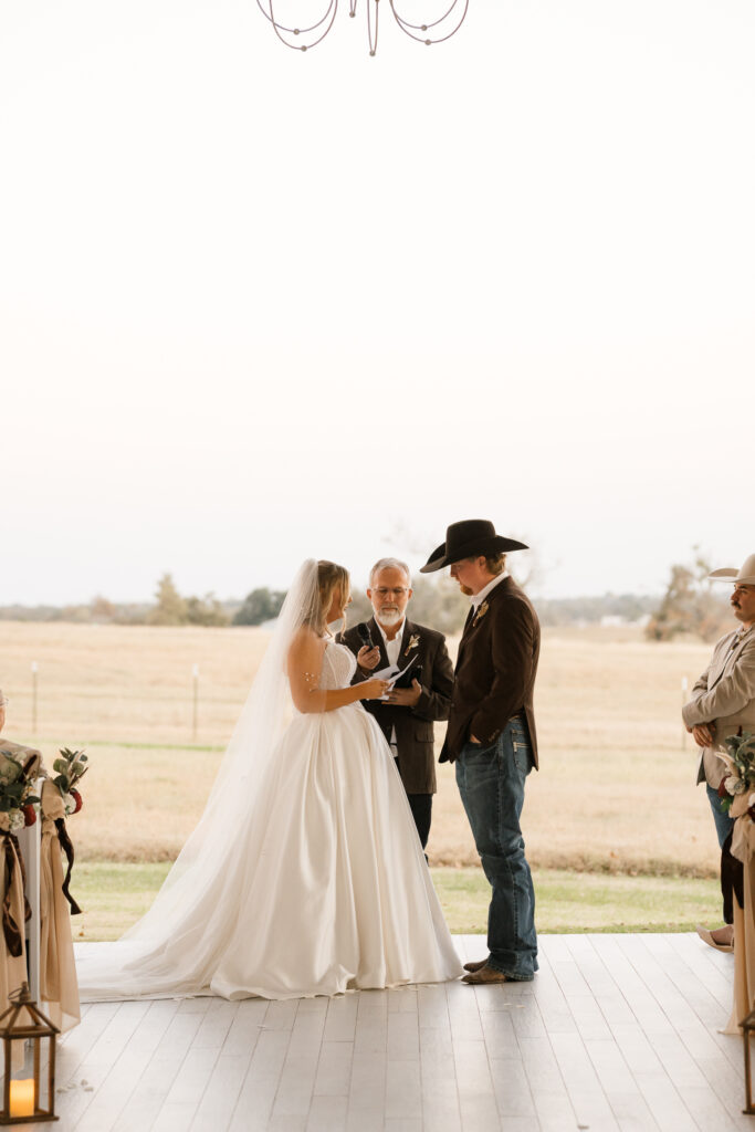 Bride and groom exchanging vows inside Chandelier Farm chapel

