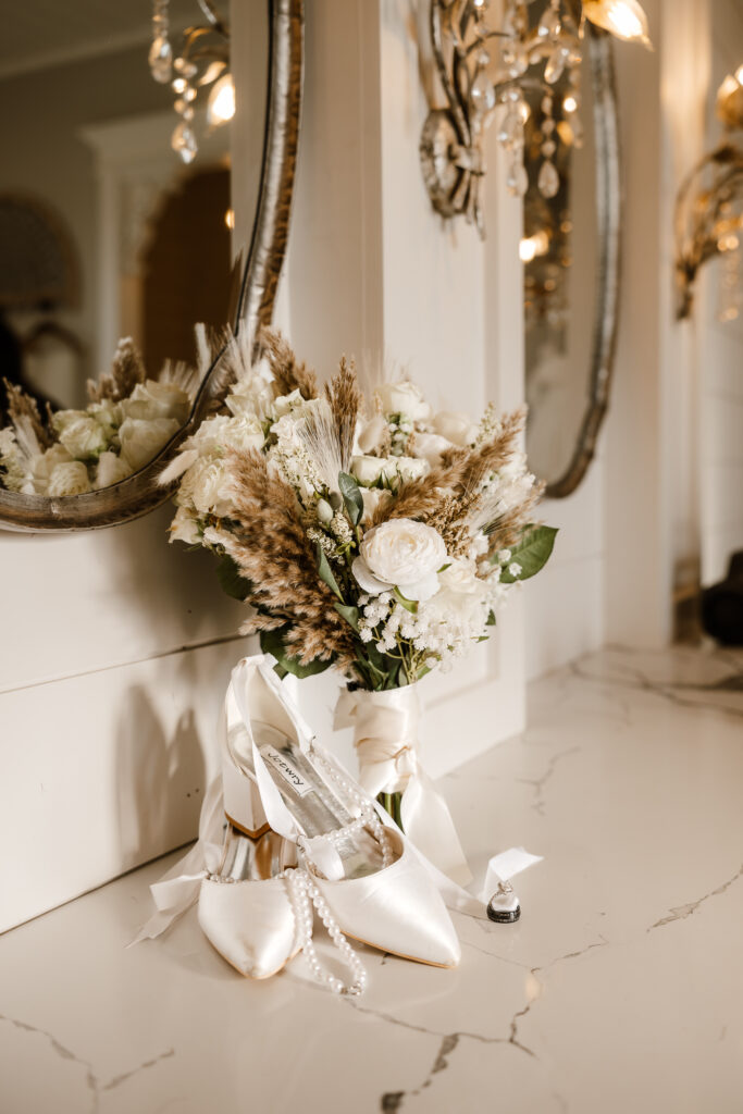 Wedding detail flat lay with rings and invitation at Chandelier Farm
