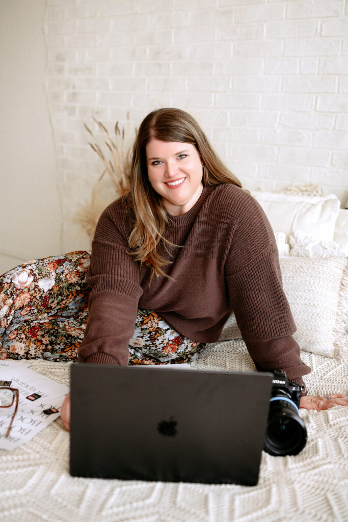 Shelly Voss poses for a picture in front of her computer and gear during her branding session in mckinney,texas.