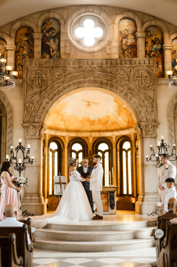 Couple exchanging vows during wedding ceremony at Bella Donna Chapel
