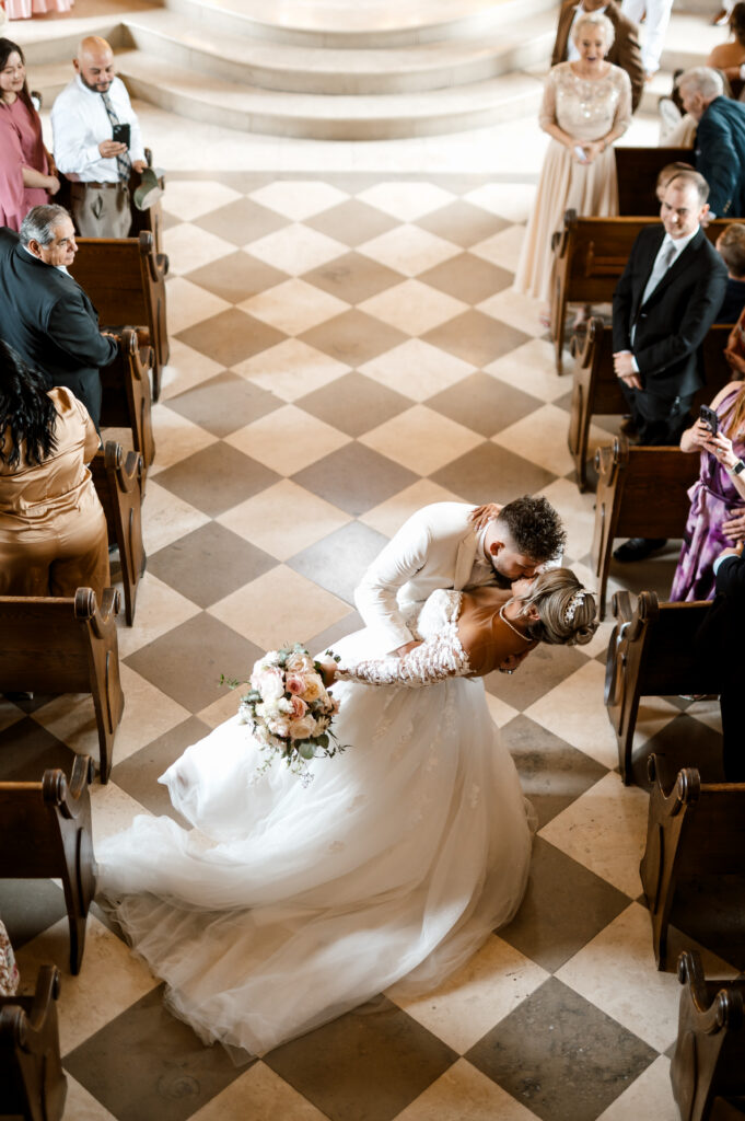 First kiss as newlyweds inside Bella Donna Chapel wedding ceremony in McKinney Texas