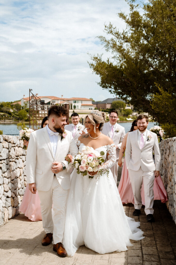 Wedding party gathered outside Bella Donna Chapel for group portraits in McKinney Texas