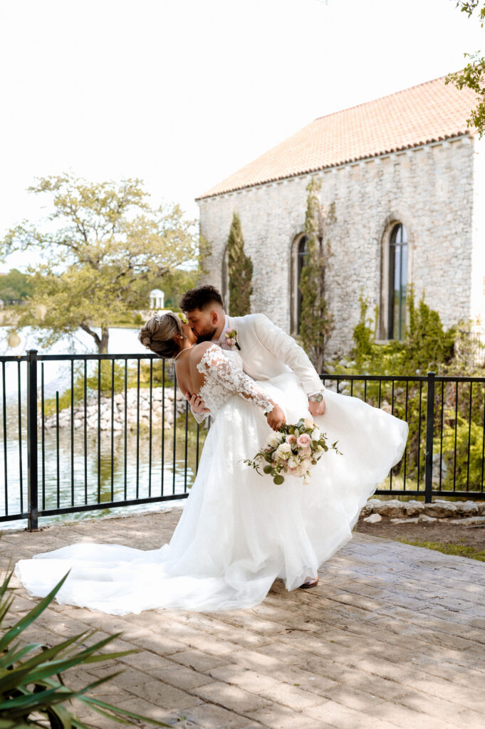 Romantic bride and groom portraits outside Bella Donna Chapel with Adriatica stone architecture backdrop
