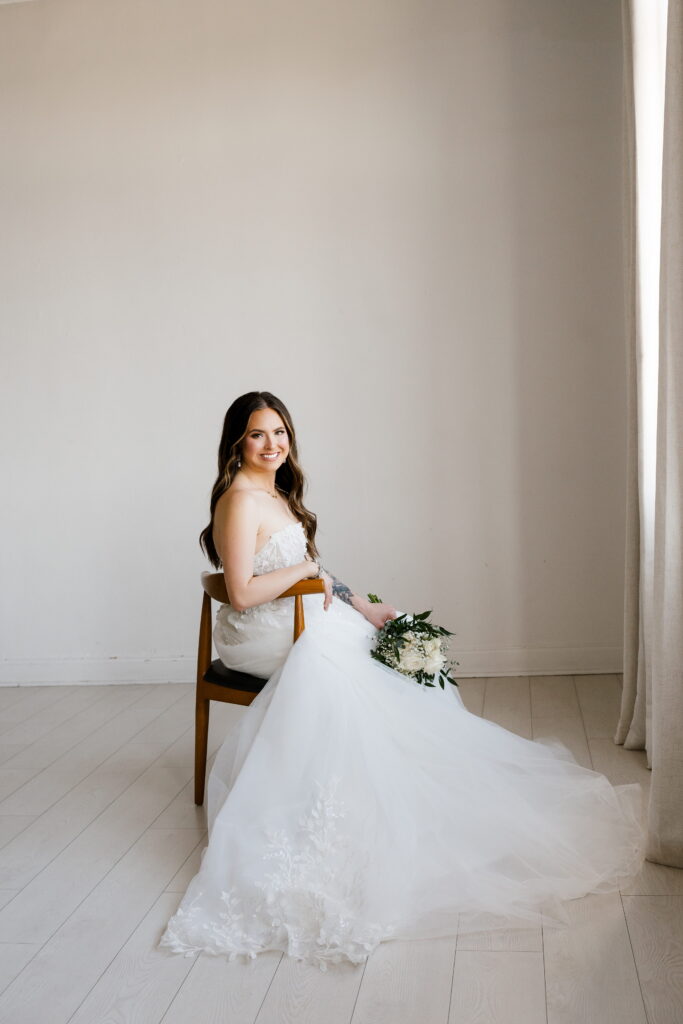 bride poses in a chair for her bridal session with shelly voss photography