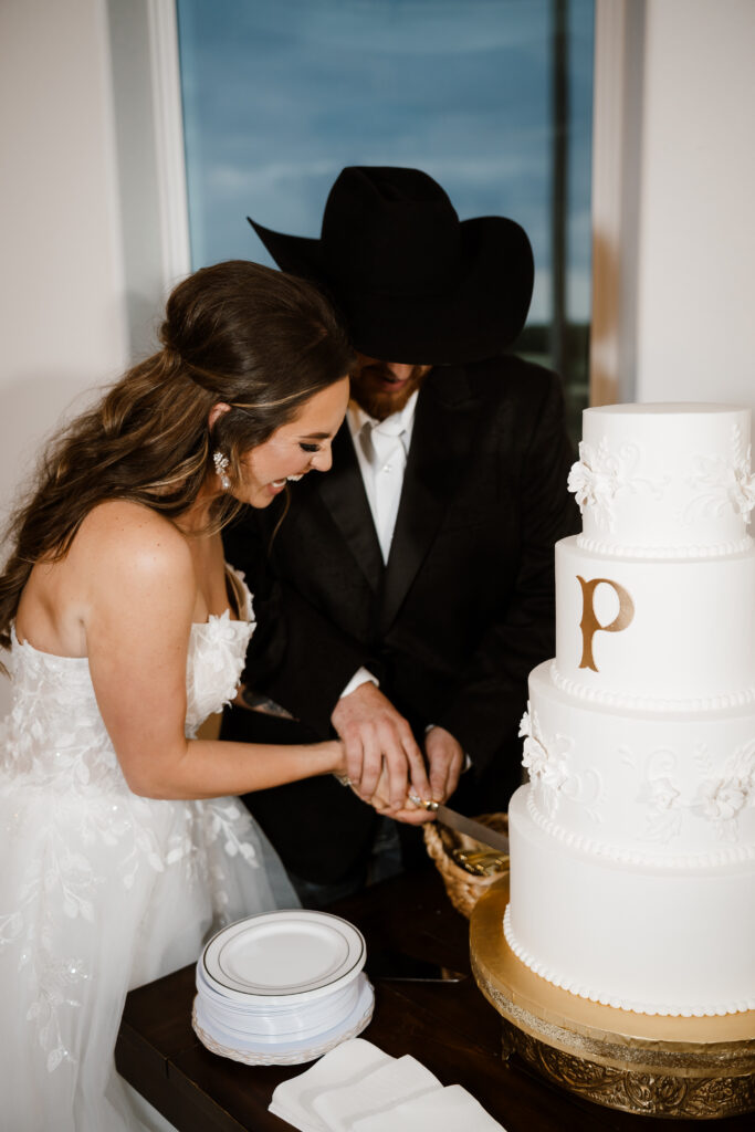 bride and groom cut their wedding cake during their reception while shelly voss captures their farmersville wedding.