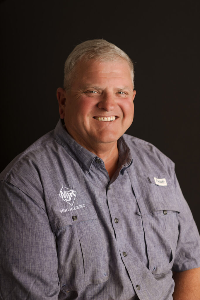 professional headshot in front of a black backdrop in studio