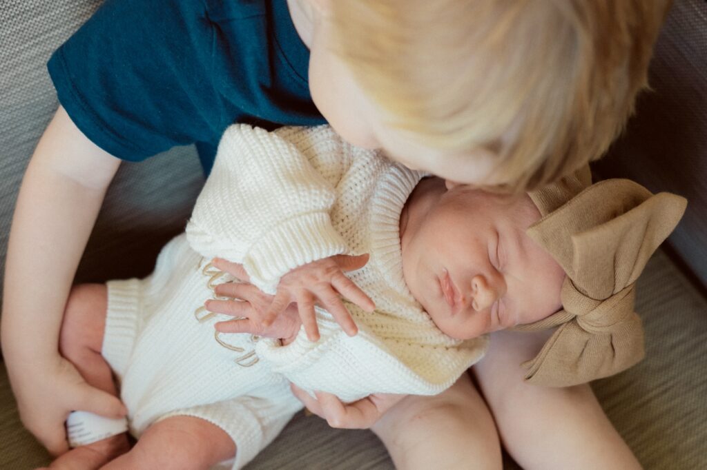 little brother cuddles his new baby sister during her fresh 48 session